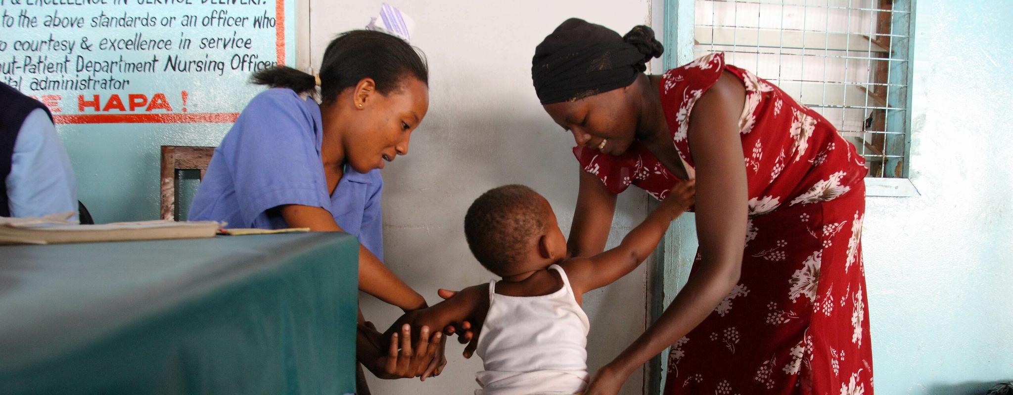 A child has her weight taken at the malaria vaccination ward at the Kilifi County referral hospital Outpatient Department in Kilifi, Kenya.