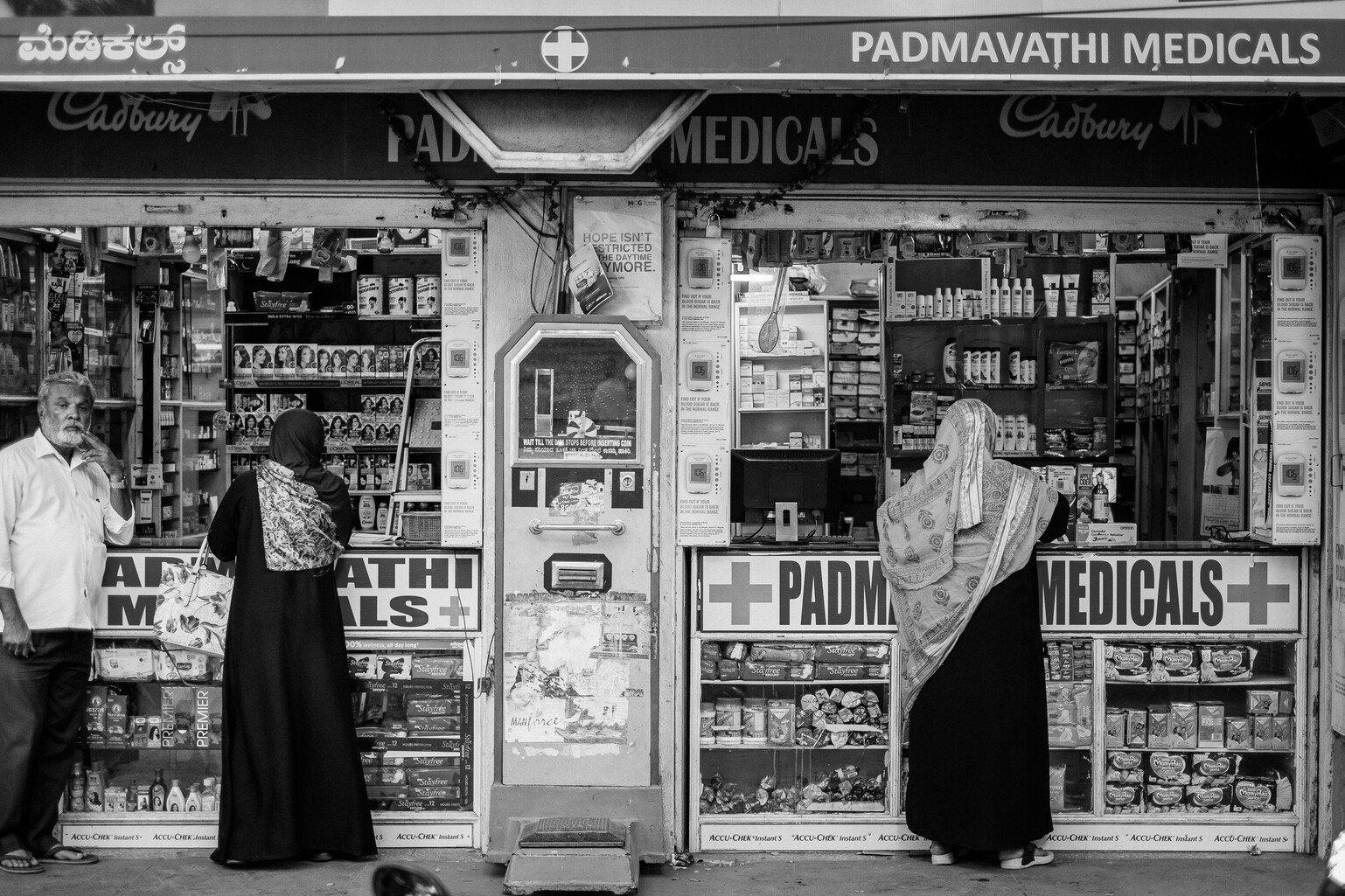 People outside a pharmacy in India