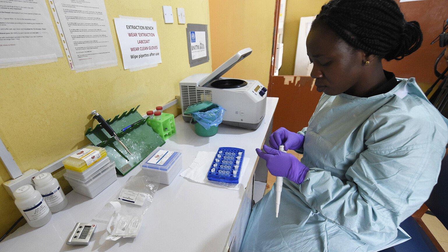 A health official works in the laboratory extraction room of the Institute of Lassa Fever Research and Control in Nigeria.