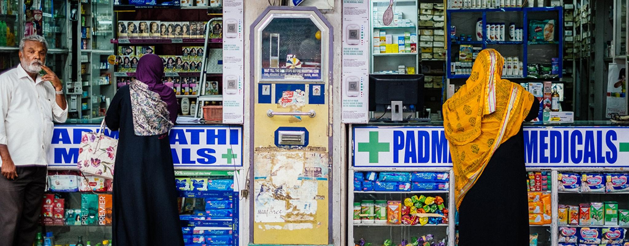 People outside a pharmacy in India.