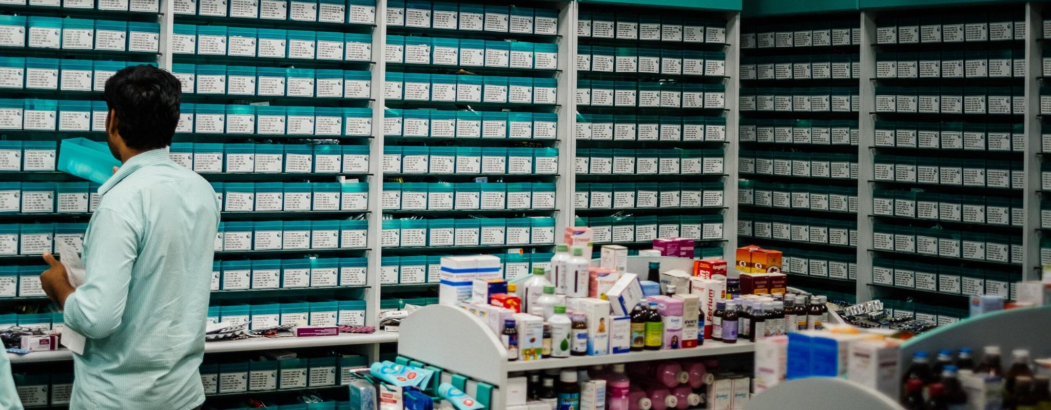 Man taking medicines off the shelf