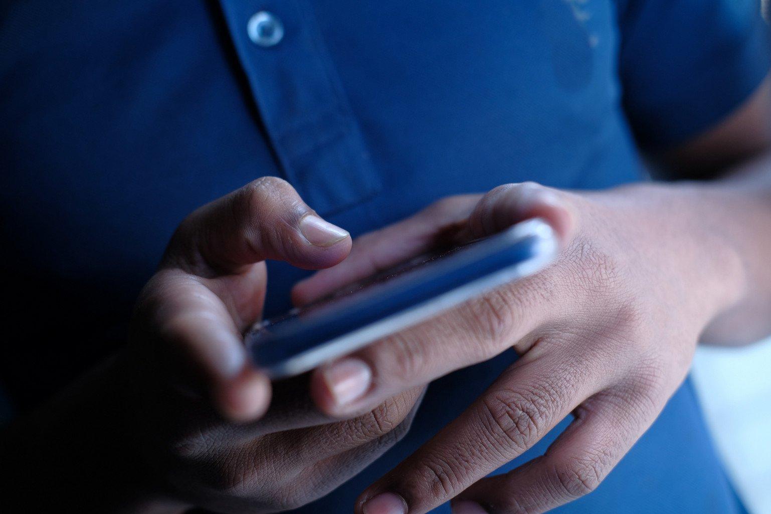 Close up of a young man using a smartphone