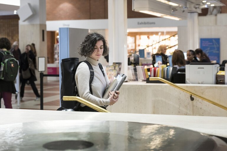 Emilie walking with books in her hands