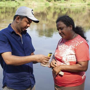 Upul and Anusha look at the water test results