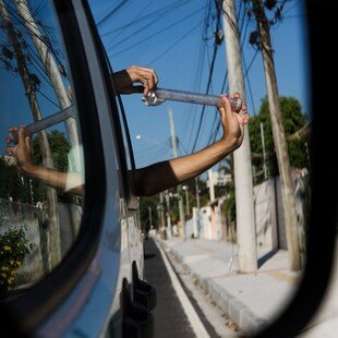 Man releasing a tube of mosquitoes that carry Wolbachia from his car window