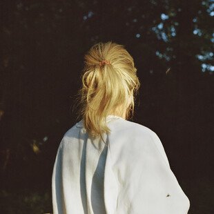 A woman with her back to the camera on a walk, not long after the start of lockdown