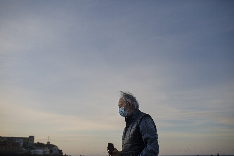 A man wearing a facemask is out for a walk 