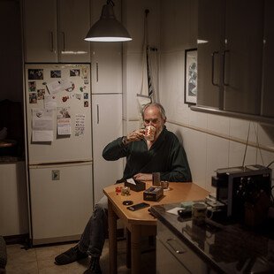 A man has a coffee while looking at his new cannabis vaporiser