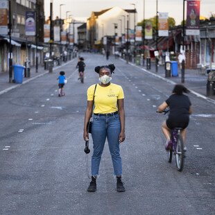 A portrait of a masked pedestrian on London's Ridley Road. 