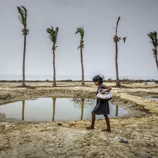 A girl carries water for her family, in a remote village in West Bengal, India. 