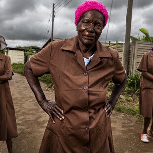 A trio of grandmothers, volunteers for Zimbabwe's Friendship Bench programme, stand at the ready.