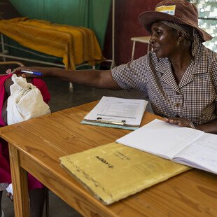 Counsellor Aleta Gukwa comforts new patient Apolonia Mekadha, who is homeless and unemployed.