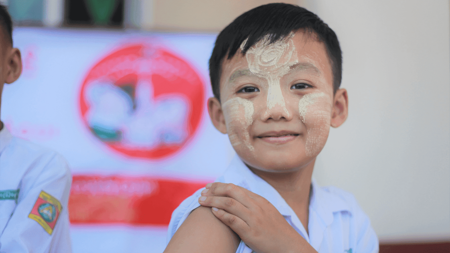 A young boy holds his arm